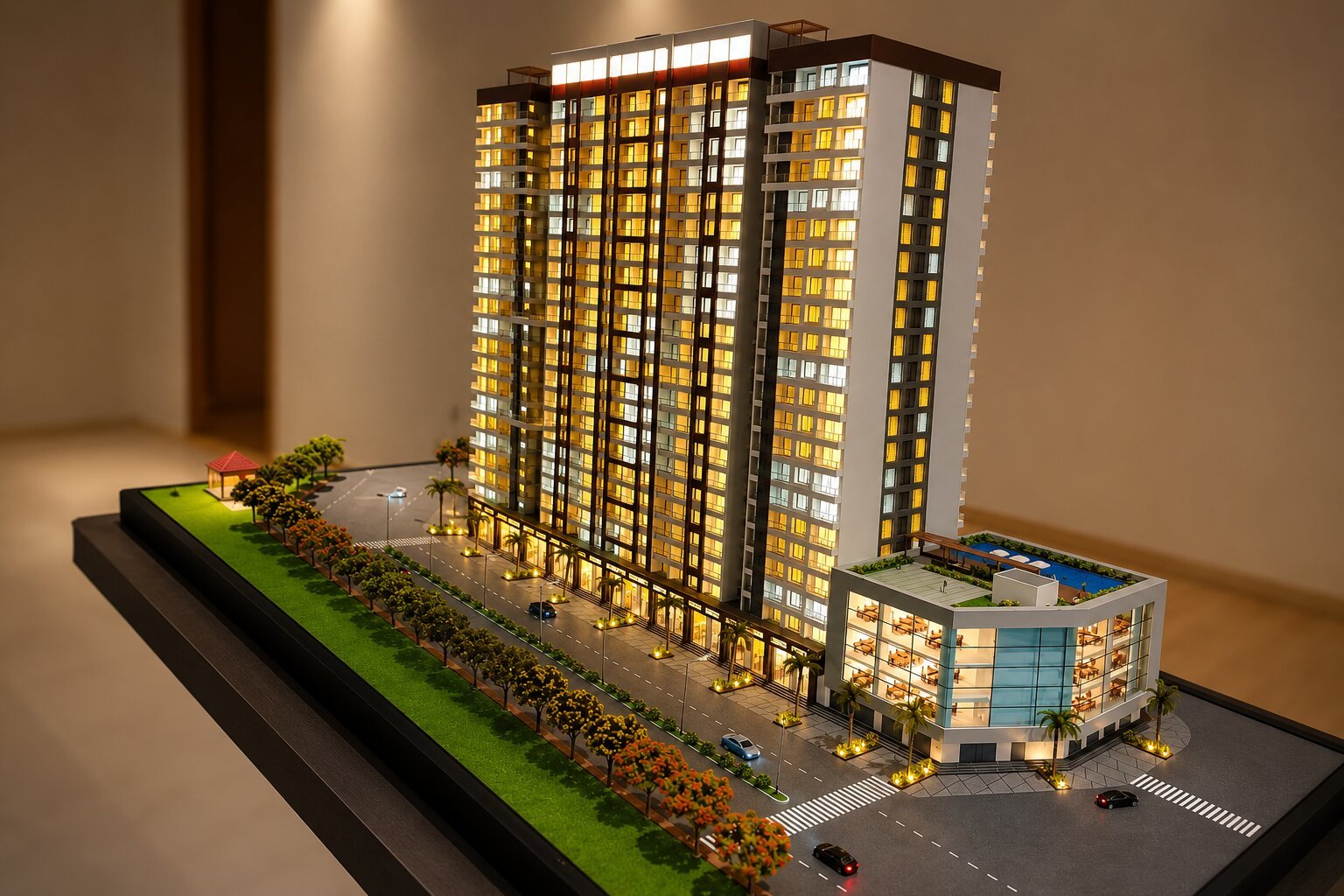 Detailed luxury residential complex model featuring elegant apartment blocks, landscaped gardens, recreational facilities, internal driveways, pedestrian paths, balconies, and a professionally finished base