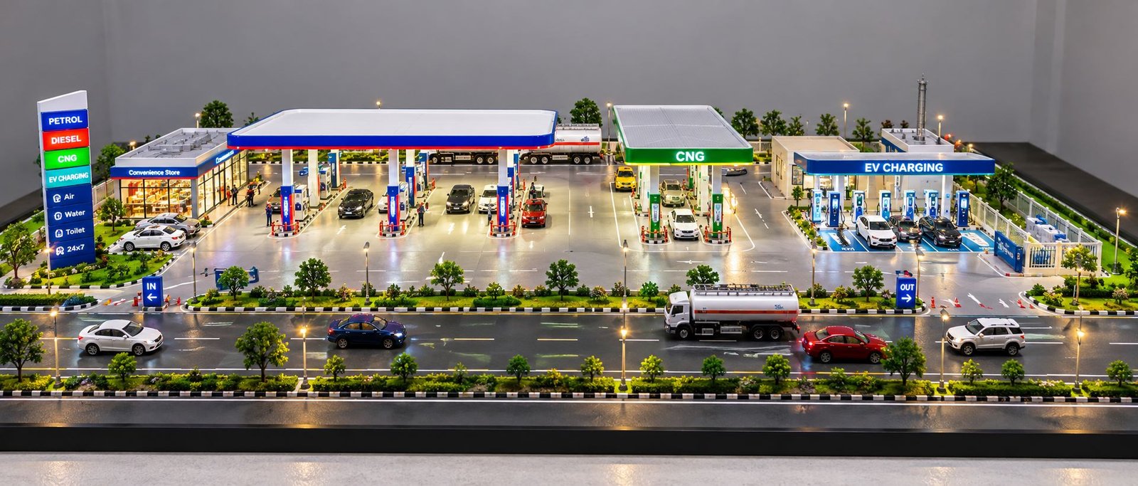 Physical petrol pump, CNG and EV charging station scale model with roadside layout, fuel dispensers, charging bays and vehicles